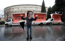 An activist wearing a mask of Forza Italia party leader Silvio Berlusconi poses during a tour, the day after Italy's parliamentary elections, in Rome, Italy March 5, 2018. 